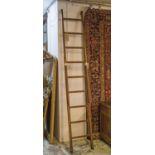 EXTENDING LIBRARY STEPS, 19th century elm and brass bound extending ten tread with brass clasp,