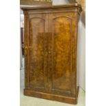 WARDROBE, Victorian burr walnut with two arched panelled doors enclosing double hanging space,