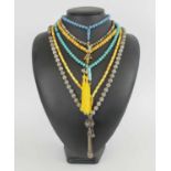 TWO BUTTERSCOTCH AMBER WORRY BEAD NECKLACES, a turquoise worry bead necklace with gold tassel,