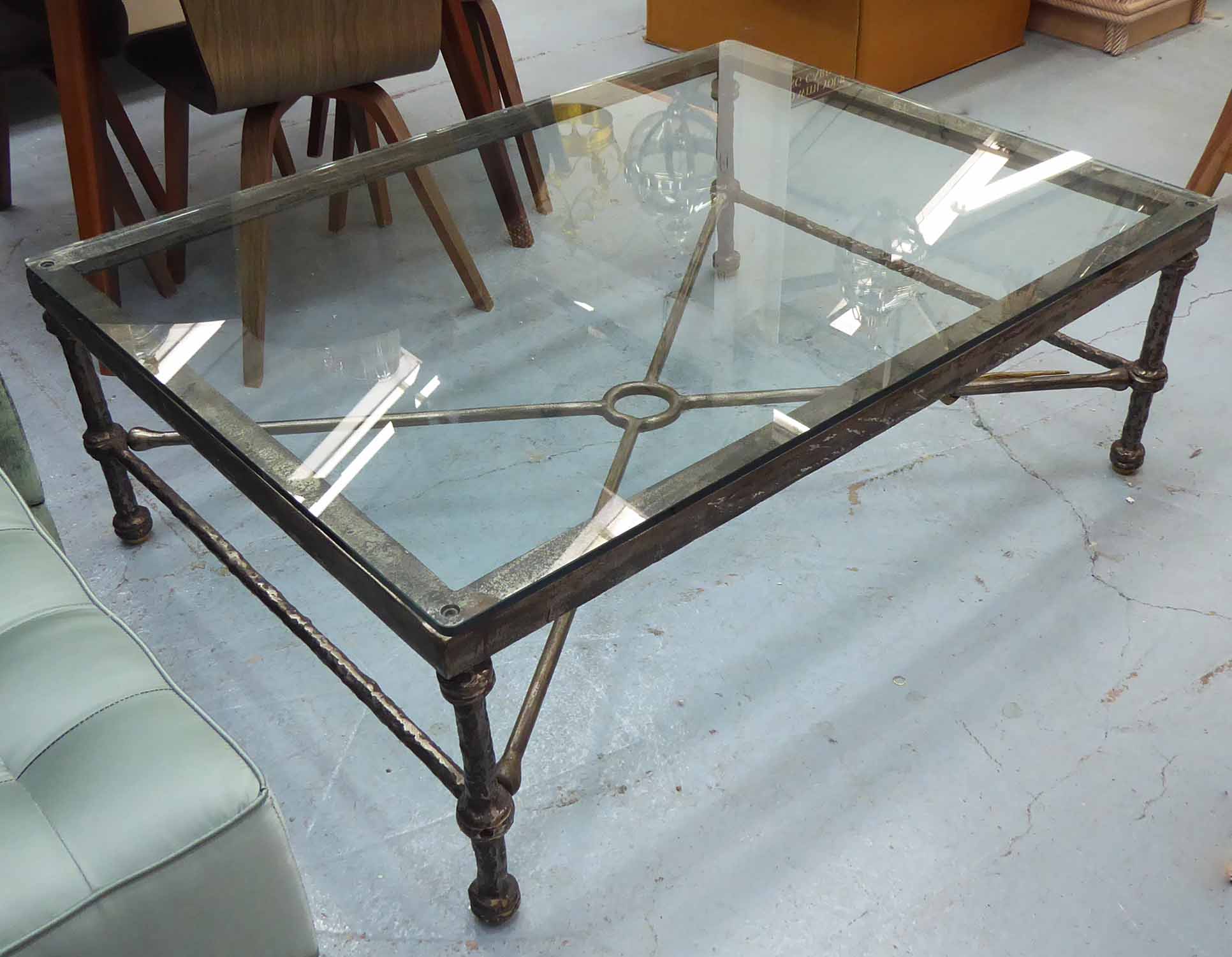 LOW TABLE, Giacometti style, the glass top on a wrought metal base with brass snake detail,