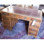 CAMPAIGN STYLE DESK, yewwood and mahogany, the tooled burgundy inlaid top over nine drawers,