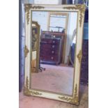 WALL MIRROR, Louis Philippe, the rectangular plate with a cream frame and gilt detail, 86cm x 142cm.