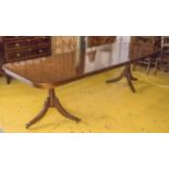 DINING TABLE, Georgian style mahogany with two centre leaves on twin pedestals and castors,