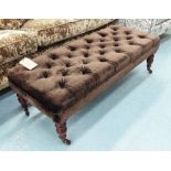 FOOTSTOOL, buttoned top in brown velvet on turned supports with castors, 123cm x 54cm x 41cm H.