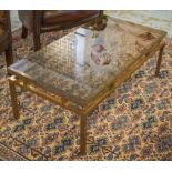 LOW TABLE, 1970's, rectangular lacquered brass step frame and tinted glass top,
