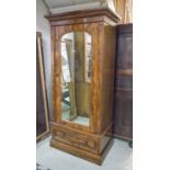 WARDROBE, Victorian mahogany with single arched mirror panelled door enclosing hanging with drawer,