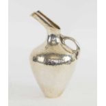 LALAOUNIS, a small planished silver pitcher, signed.