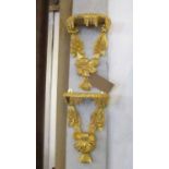 WALL BRACKETS, a pair, gilt, each with leaf and flowerhead decoration, 25cm W x 40cm H.