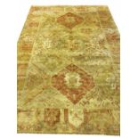TURKISH OUSHAK CARPET, 268cm x 184cm, of repeat medallion field in shades of gold.