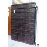 INDEXING CABINET, with thirty drop front compartments, 128cm x 38cm x 192cm H.