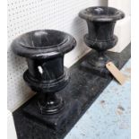 URNS, a pair, black marble, 35cm H.