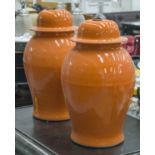 VASES, a pair, Chinese orange glazed ceramic with covers, 49cm H.