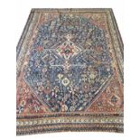 FINE ANTIQUE QASHQAI RUG, 230cm x 164cm, of ivory medallion on sapphire field.