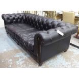 CHESTERFIELD SOFA, in black buttoned leather, of substantial proportions with studded detail,