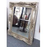 MIRROR, bevelled, in an ornate silver plated frame, 135cm x 107cm.