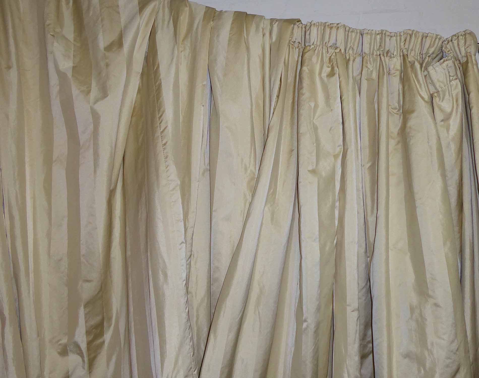 CURTAINS, a pair, in cream stripe, lined and interlined, each curtain 185cm W gathered x 248cm drop.