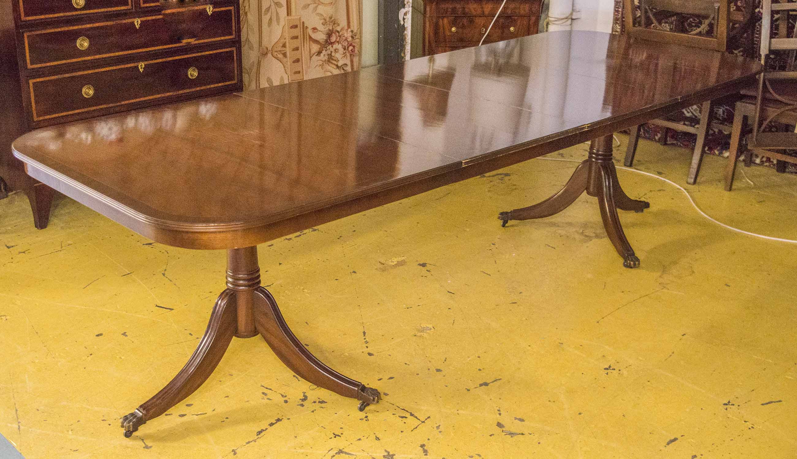 DINING TABLE, Georgian style mahogany, with two centre leaves on twin pedestals and castors,