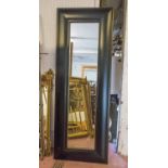 WALL MIRROR, ebonised with broad rectangular frame, 222cm x 80cm.