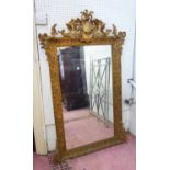 WALL MIRROR, late 19th century French, with a decorative gilt frame, 84cm W x 140cm H.