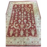 BAKSHAISH RUG, 233cms x 164cms of scrolling vines and palmettes, on ruby field, within ivory field.