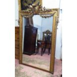 OVERMANTEL MIRROR, late 19th century, French giltwood and gesso, with decorative surmount,
