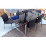 DINING TABLE, the verre noir top on brushed aluminium supports,