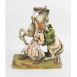 A LARGE AUSTRIAN CERAMIC FIGURE OF A REARING HORSE, and keeper, circa 1920, 42cm H.