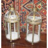 GARDEN LANTERNS, a set of four, each with a handle to the domed top and glazed panels, 52cm H.