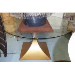 TOM FAULKNER DINING TABLE, circular the glass top on a geometric gilt metal base, 150cm W.