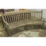'COUNTRY HOUSE' CURVED GARDEN BENCH, weathered teak, of substantial proportions,