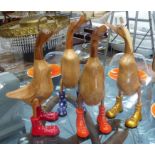 WOODEN RUNNER DUCKS, a set of four, contemporary design, carved natural wood, 44cm H.