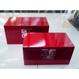 JEWELLERY BOXES, a graduated pair, Oriental inspired red finish, widest 35cm.