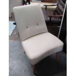 ARMCHAIR, faux cream leather on circular supports, 60cm W.