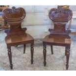 HALL CHAIRS, a pair, William IV mahogany with carved scroll back,