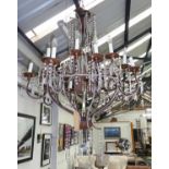 CHANDELIER, two tiers each with eight sconces, the metal frames with cut glass droplets,