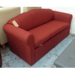 SOFA BED, in red fabric on block supports, 165cm long.