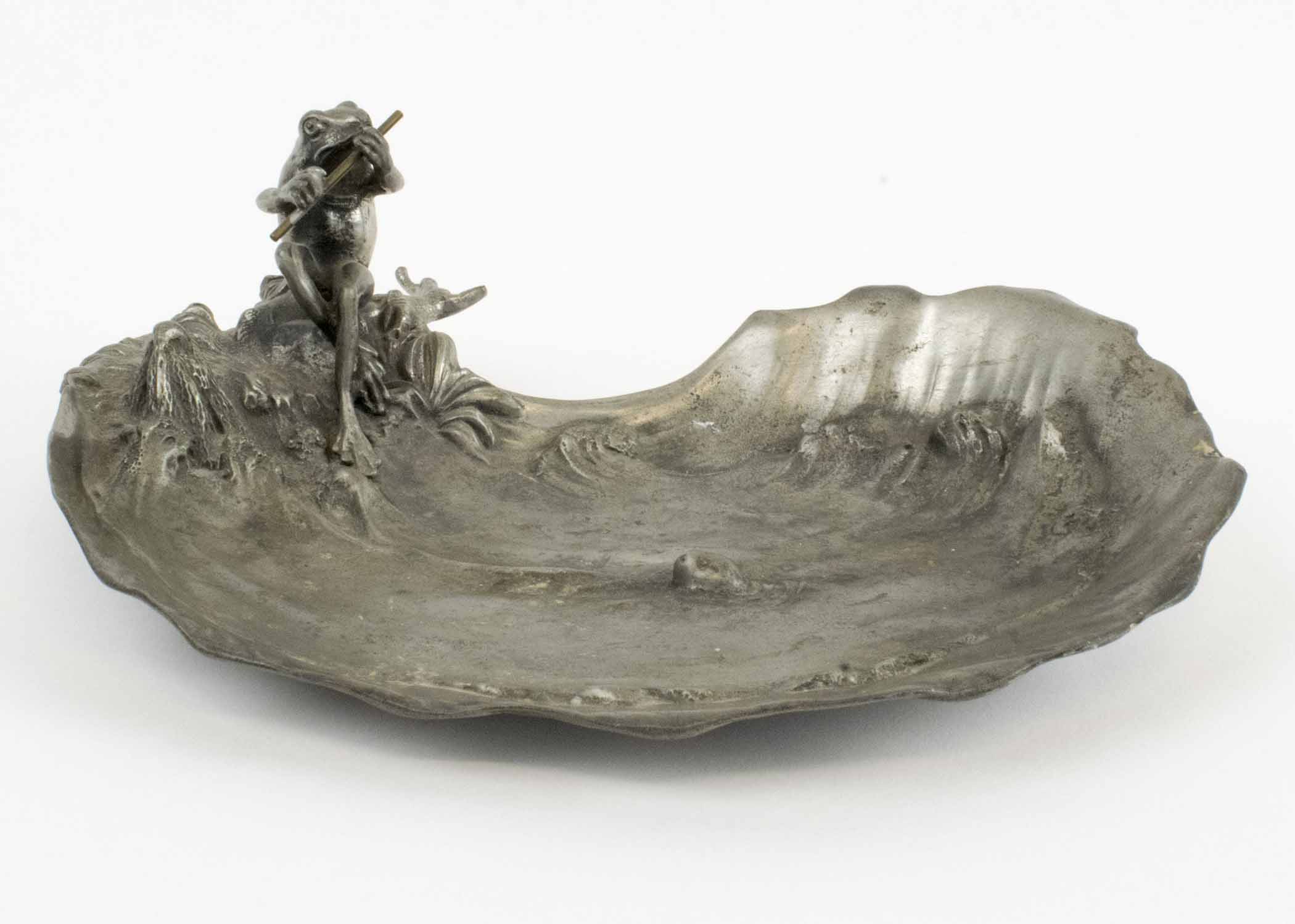 A PEWTER ART NOUVEAU PLATE, depicting a frog fishing in a raging river.