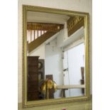 WALL MIRROR, rectangular bevelled mirror in a finely beaded foliate frame, 90cm x 120cm H.