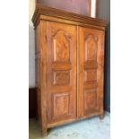 CUPBOARD, Indian teak with twin carved panel doors fitted with shelves, 149cm H x 102cm W x 49cm D.