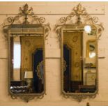 WALL MIRRORS, a pair, Renaissance style silvered metal with scrollwork and leaf crest,