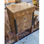 COMMODE, Biedermeier walnut and ebonised with columns flanking three drawers, 57cm x 45cm x 85cm H.