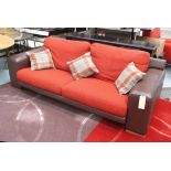 SOFA, two seater with red fabric cushions on block supports, plus three scatter cushions, 222cm L.