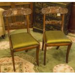 SIDE CHAIRS, a pair, Regency mahogany each with green silk cushion and sabre front supports.