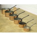 BATTERIE DE CUISINE, a set of six, vintage graduated copper pans, with pierced handles,