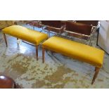 STOOLS, a pair, each with gold upholstery on reeded turned supports, 99cm W x 47cm H x 40cm D.