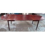 DINING TABLE, rosewood extending with a drop flap to each end and extra leaves on turned supports,