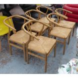 DINING ARMCHAIRS, a set of six in the style of Hans Wegner in bent birchwood with rush seats,