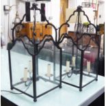 HALL LANTERNS, a pair, shaped black metal frames with hanging sconces, 30cm x 30cm x 72cm H.