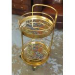 TROLLEY, Art Deco style gilt metal framed two tier, each with a circular mirrored top on wheels,