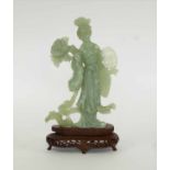 A CHINESE CARVED CELADON COLOURED JADE FIGURE OF A LADY,